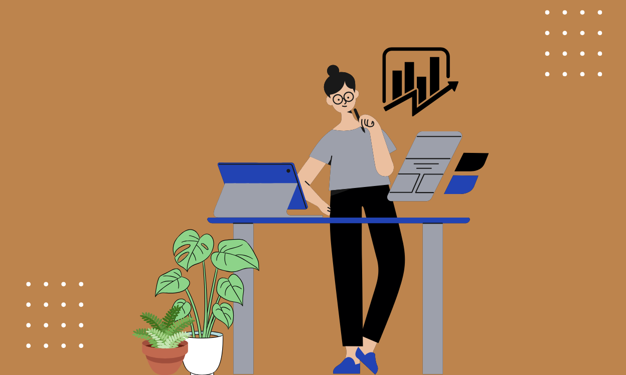 A woman sits at her desk, working on a laptop, with a green plant beside her, creating a productive workspace.